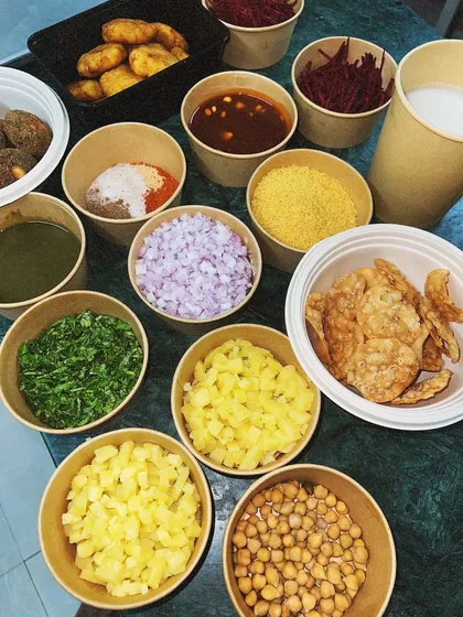 A deconstructed chaat kit, delivered with all the components packed separately. This DIY kit includes papdi, dahi bhalla, potatoes, chutneys, and spices, so you can assemble it fresh at home.