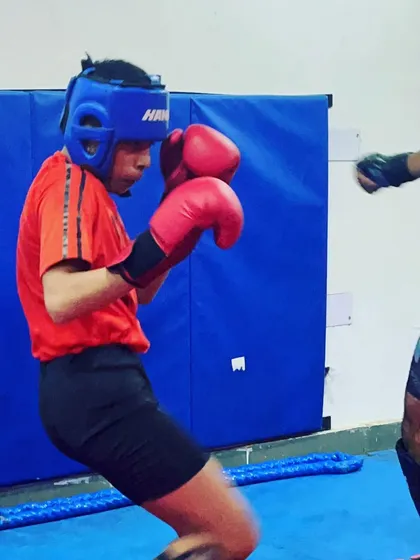 Our student practices defensive movements during a sparring session. Learning to block and evade punches is just as important as learning to attack. This is a key part of our self defense and MMA curriculum.