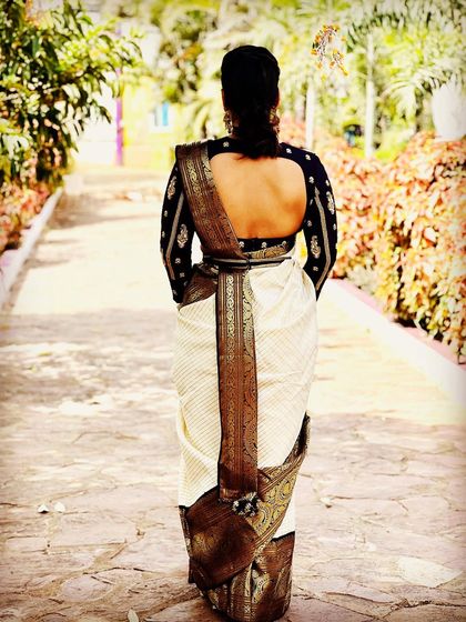 The elegance of a Kanjeevaram saree is elevated with a custom-designed blouse, seen here from the back, showcasing the fit and drape.