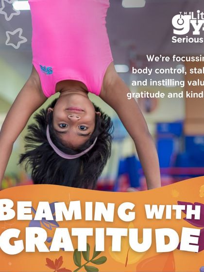 This young gymnast hangs upside down, a perfect example of the body control and stability we focus on. These activities are part of my 'Beaming with Gratitude' theme, where we also instill values of kindness.