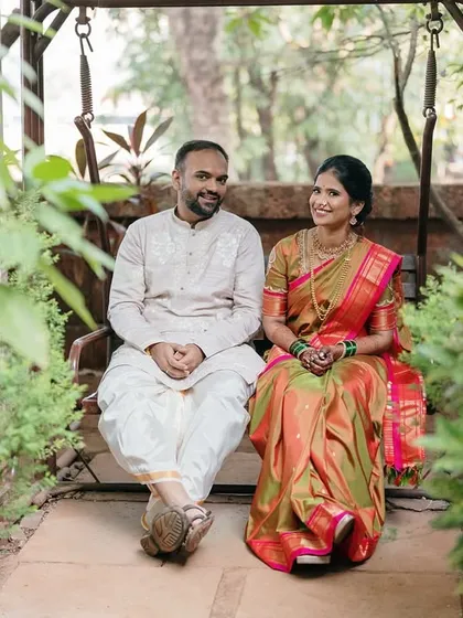 A peaceful moment shared on a garden swing. This shot captures the couple in a relaxed and natural setting, away from the bustle of the ceremonies.