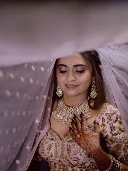 A beautiful, artistic shot of the bride under her veil, her eyes closed in a moment of quiet contemplation.