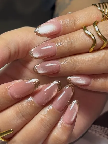 A sophisticated and modern bridal look. We used a soft cat-eye polish to create a subtle shimmer and finished with a delicate gold chrome French tip for a touch of glamour.