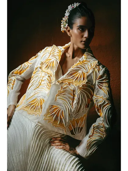 A structured jacket and pleated pants from Vaishali S. The styling is sharp and modern, showcasing how the designer's organic textures can be applied to contemporary silhouettes.