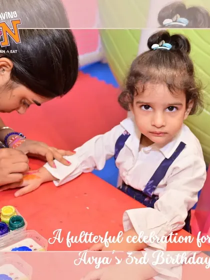 A moment of creativity during a butterfly-themed party. A young guest gets her hand painted, one of the many engaging activities we offer to make each celebration unique and fun.