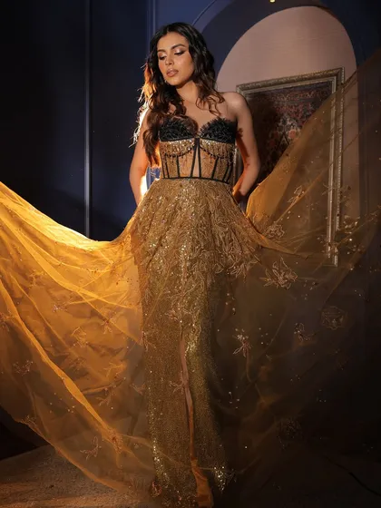 The movement of this gown is everything. The glam makeup with a smoked liner ensures the focus remains on her beautiful face.