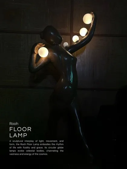 The Rooh Floor Lamp is a sculptural interplay of light, movement, and form. The figure embodies the rhythms of life with grace, while its circular glass lamps evoke celestial bodies, channeling the vastness and energy of the cosmos.