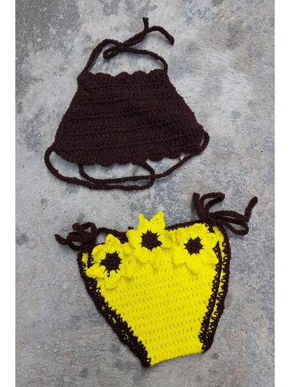 A variation of my sunflower bikini design. This set features a brown halter top paired with a bright yellow bottom, both adorned with my signature crochet sunflowers.
