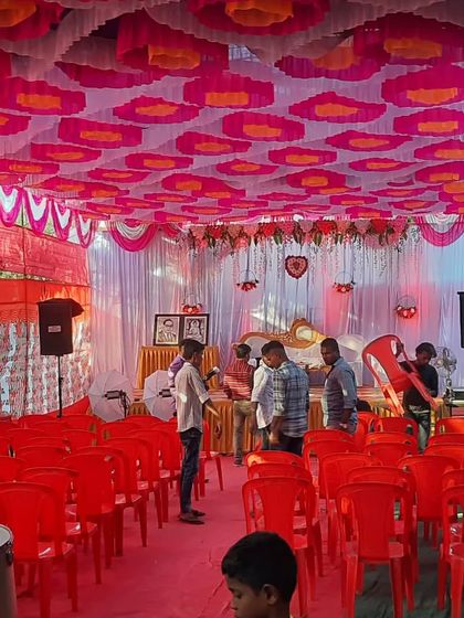 A behind the scenes look at an engagement event being set up, showing the colorful ceiling decor and seating arrangement before guests arrive.