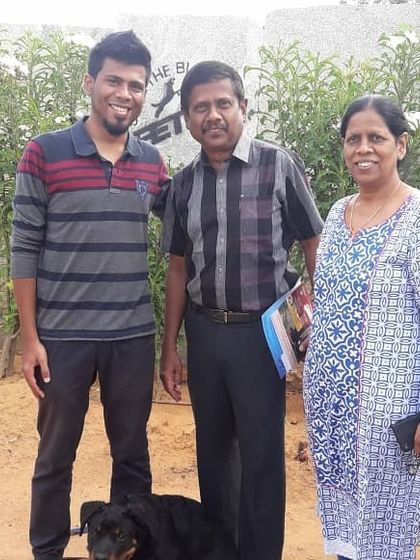 A family celebrating the graduation of their Rottweiler. It's a team effort, and their commitment has paid off.