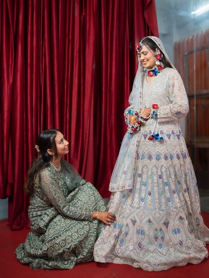 A sweet moment between the bride and her bridesmaid. These candid interactions add a layer of warmth and personality to the wedding album.