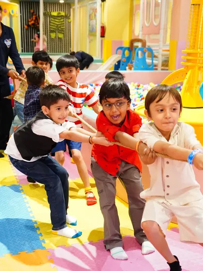 The determination and teamwork during a game of tug-of-war. Group activities like this are fantastic for building social skills.