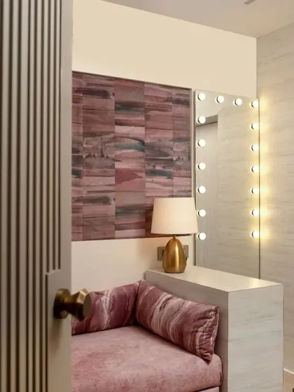 The daughter's pink room in the Mulund project. It's a cozy haven with a dedicated dresser area featuring a mirror with green room lights and a comfortable seating nook.