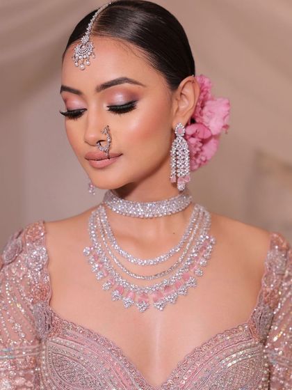 A close-up of a monochromatic pink bridal look. The soft pink eyeshadow and matching lip create a dreamy, romantic vibe.