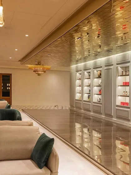 The experience center we designed for a premium chocolate brand exudes sheer grace and luxury. The long, gallery-like space features a reflective gold ceiling, plush seating, and beautifully lit display cabinets to showcase the products like jewels.