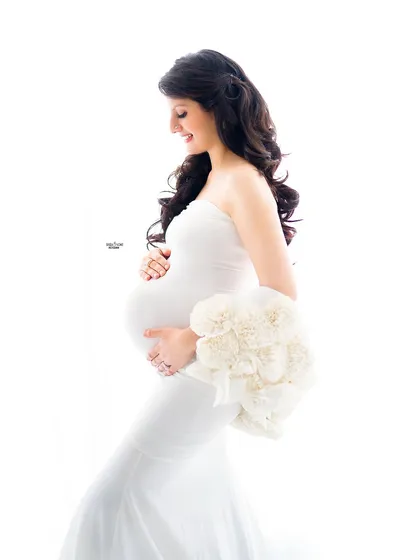 A joyful and classic high-key maternity pose. We'll focus on capturing genuine smiles and the happy anticipation of motherhood.