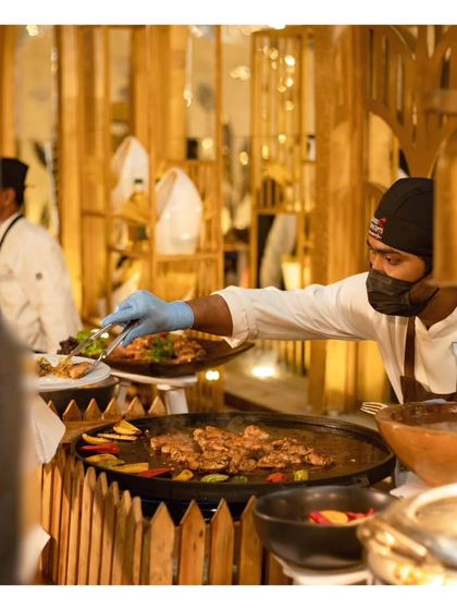 A guest is served directly from a live teppanyaki style grill. This interaction between chef and guest is central to the appeal of our live stations, making the dining experience personal and engaging.