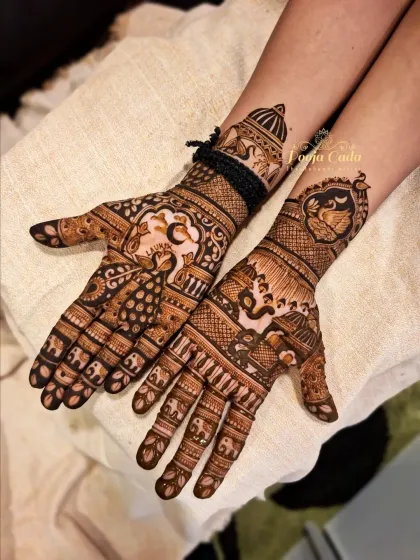 This Karwa Chauth design combines classic symbols with detailed artistry. The palms feature majestic peacocks and elephants, with a traditional palanquin (doli) motif on the wrist.