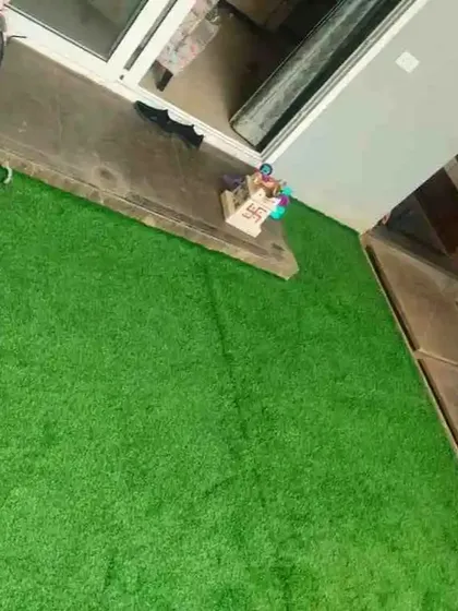 This is a straightforward yet effective balcony installation. The artificial grass instantly brightens the concrete space, providing a clean and pleasant area right outside the sliding doors.