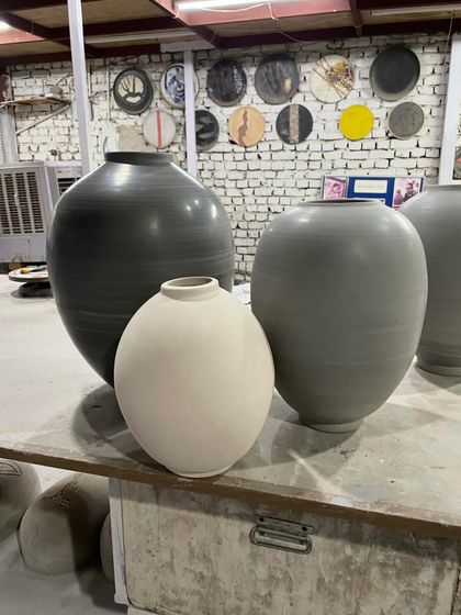 A collection of large vessels in my studio, including Moon Jars of different sizes and clay bodies, from dark grey to white stoneware.