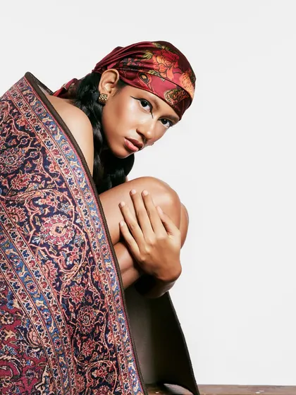 A different angle from the heritage-inspired shoot, showing how the pose and the makeup work together to create a sense of mystery and strength.