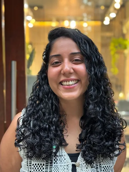 I had so much fun styling this real-life Moana. Her beautiful, long curls are accessorized with flowers and clips, showing how versatile curly hair can be.