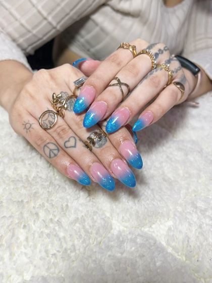 A playful pink and blue glitter ombre on long, stiletto nails. This is a fun, sparkling look that's perfect for parties.