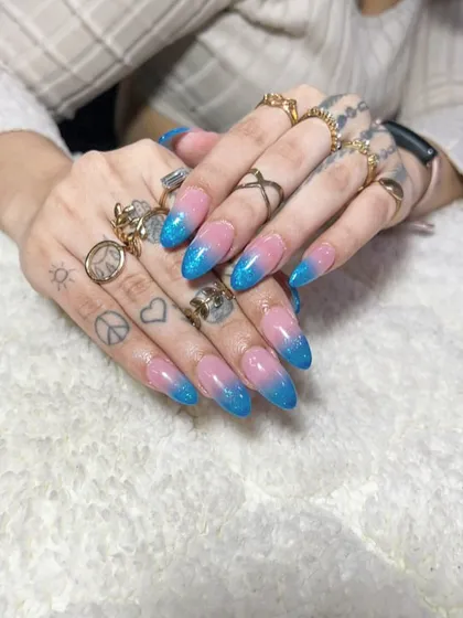 A playful pink and blue glitter ombre on long, stiletto nails. This is a fun, sparkling look that's perfect for parties.