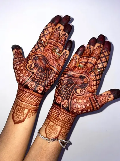 Another look at a beautifully developed henna stain. The peacock and floral motifs have taken on a deep, rich color that will last through all the wedding festivities.