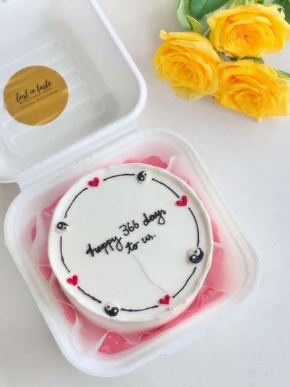Mark your anniversary with a special bento cake. This design celebrates "366 days to us" with a clean, minimalist border featuring yin-yang symbols and hearts.
