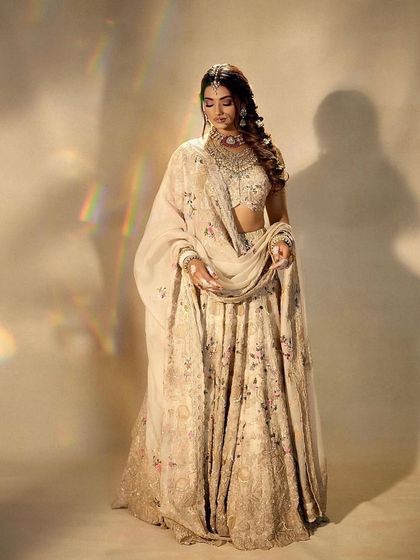 An ethereal and dreamy bridal portrait. The makeup is soft and luminous, with a focus on a flawless complexion that looks beautiful in this soft-focus, artistic shot.