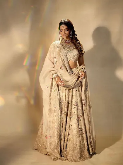 An ethereal and dreamy bridal portrait. The makeup is soft and luminous, with a focus on a flawless complexion that looks beautiful in this soft-focus, artistic shot.