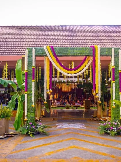 A glimpse into a traditional South Indian wedding, where every detail is steeped in culture. I designed this entrance to be grand yet welcoming, using banana stems, intricate coconut leaf weaving, and garlands of marigold and jasmine to create an authentic and auspicious atmosphere.