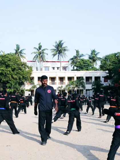I walk through the lines of students during a belt test, observing their form and ensuring they maintain discipline throughout the drill.