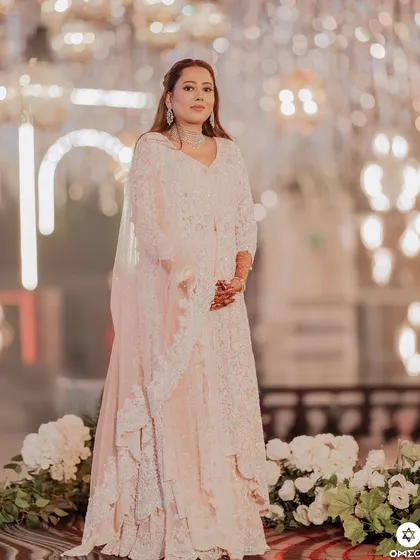 A full length shot of the bride's Sufi night look. The makeup is soft and romantic, perfectly matching the dreamy decor.