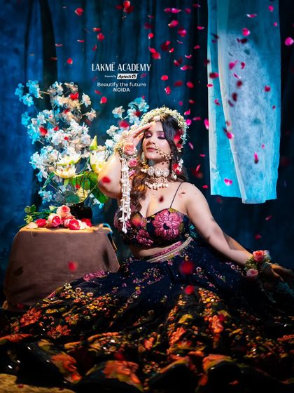 An artistic shot with falling petals, capturing the celebratory mood of a Haldi ceremony. Our portfolio shoots help students learn how to capture their work beautifully.