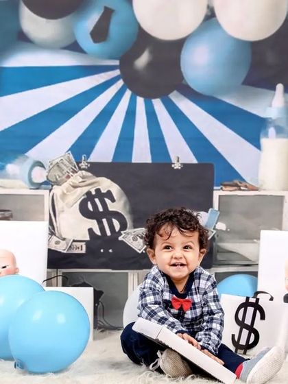 A full view of the 'Boss Baby' setup, complete with money-themed props, balloons, and a baby bottle, creating a playful and humorous scene.