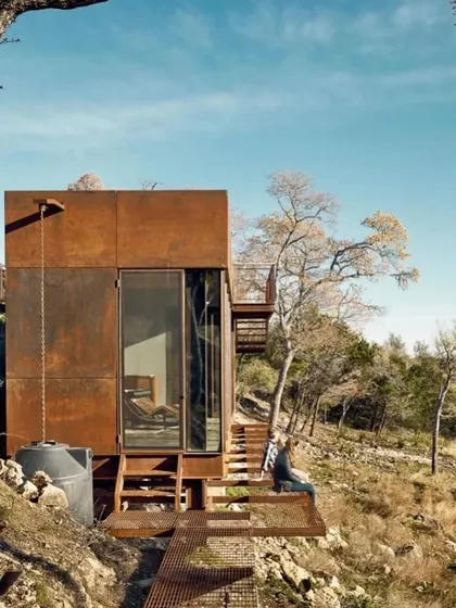 This shot highlights the clean lines and minimalist design of our modular home. The simple form, combined with large glass panels, creates a powerful architectural statement against the natural backdrop.