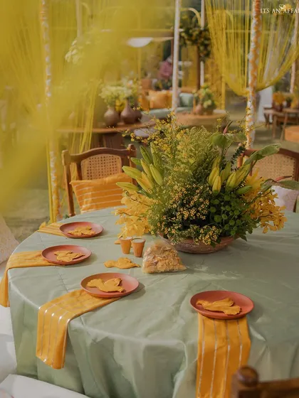 The dining tables were set with a soft green cloth and yellow runners, complemented by traditional terracotta plates.