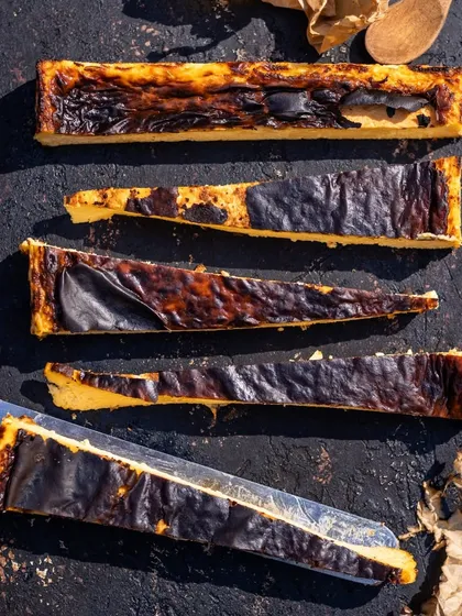 Some heavenly slices of the Basque cheesecake, showing off its beautifully caramelized top and creamy interior.