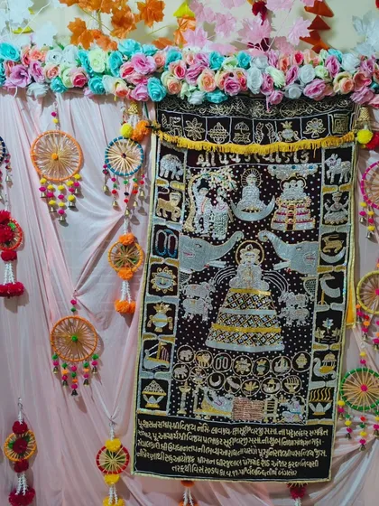 Here is a vibrant backdrop for a Kalpasutra puja. I centered the family's embroidered Kalpasutra tapestry and surrounded it with colorful handmade dream catchers, artificial flower garlands, and soft pink drapes to make it the focal point of the home.