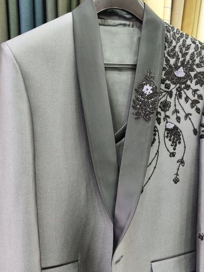 A collection of our designer suits, showcasing a variety of colors, fabrics, and custom details like embroidery, unique lapels, and accessories. Each piece is crafted to make a lasting impression.