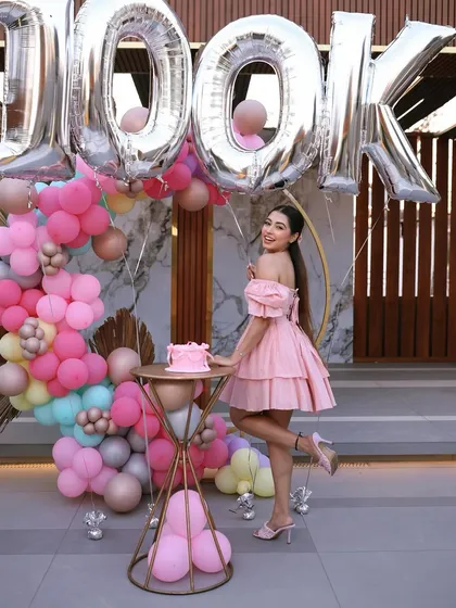 A fun, celebratory pose in front of the 100k party decor. We are so happy we could be a part of this incredible achievement.