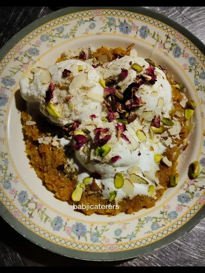 A winter classic, Gajar Halwa (carrot pudding) served with a scoop of vanilla ice cream. The warmth of the halwa with the cold ice cream is a match made in heaven.