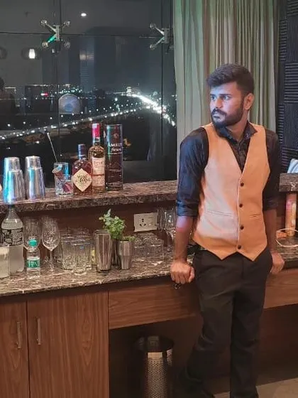 A portrait of our founder at a rooftop bar setup, overlooking the city lights. This reflects our ability to create sophisticated bar experiences in any premium venue.