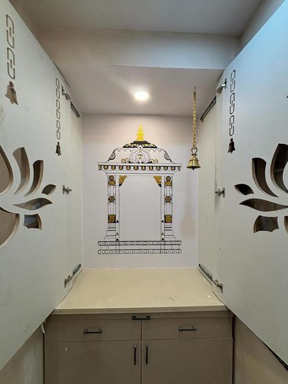 We often create temple gopuram murals for pooja nooks. This design, with its detailed pillars and golden accents, provides a beautiful, built-in frame for the sacred space, even within a compact cabinet.