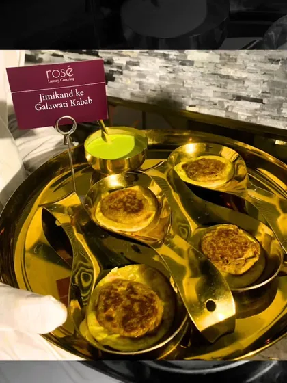 The Jimikand ke Galawati Kabab is an irresistible vegetarian delight. These tender, spiced yam patties are served on individual spoons with a side of mint chutney, showcasing our expertise in gourmet Indian appetizers.