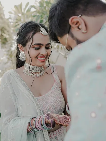 A candid moment between the happy couple on their engagement day. Her soft makeup and intricately braided hairstyle looked absolutely perfect.