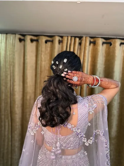 The client showing off her beautiful hairstyle. This look is perfect for a reception or cocktail party.