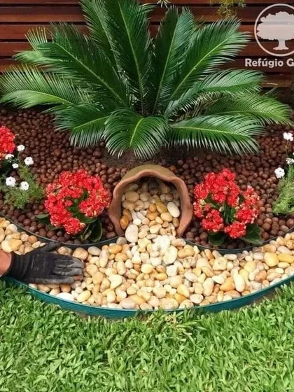 Here I am putting the finishing touches on a garden bed. I use professional-grade edging to create clean lines between the lawn, pebbles, and planted areas for a tidy, well-defined look.